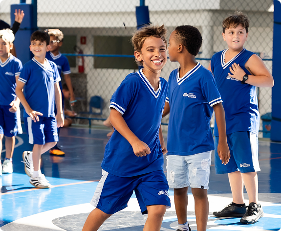 Alunos sorridentes brincando na quadra do colégio